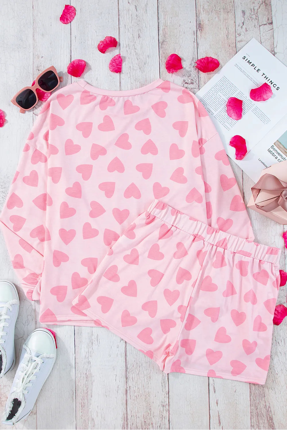 Blush pink long sleeve top and shorts lounge set with all-over heart print, soft fabric.