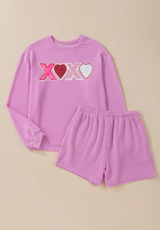 Pink long sleeve top with XOXO heart sequin design and matching elastic waist shorts set.