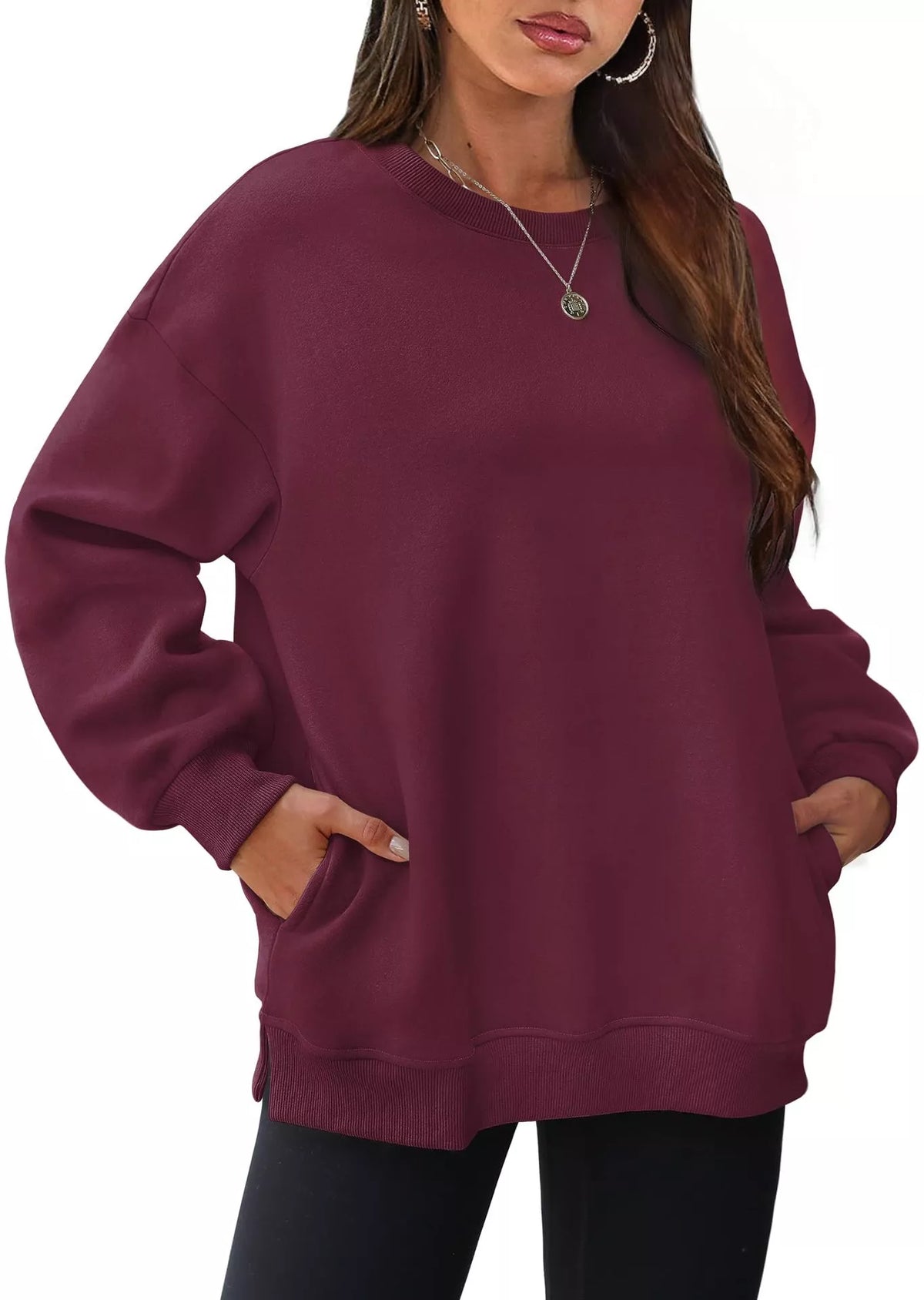 Burgundy long sleeve sweatshirt with relaxed fit and front pockets worn by woman.