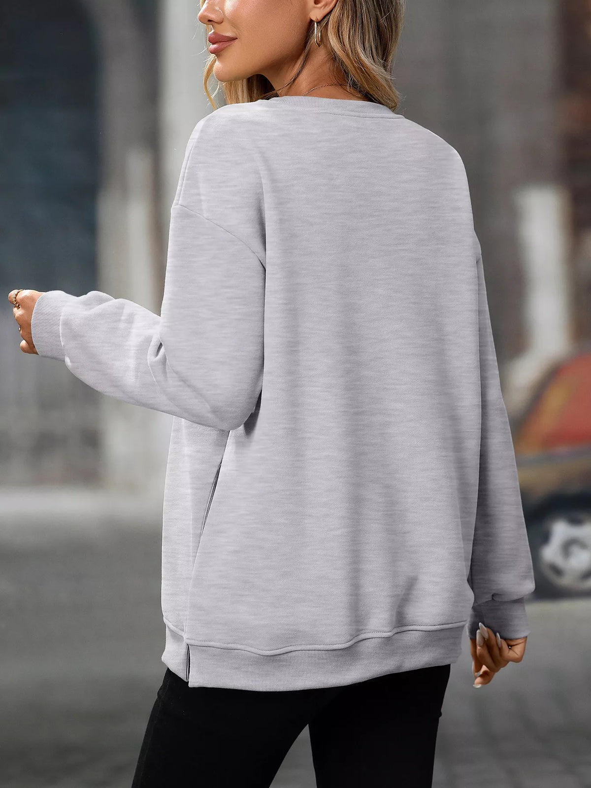 Light gray casual long sleeve sweatshirt with relaxed fit and ribbed cuffs and hem.