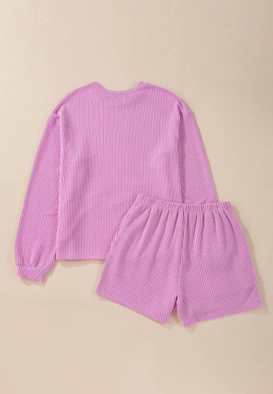 Pink ribbed long sleeve top with matching elastic waist shorts set.