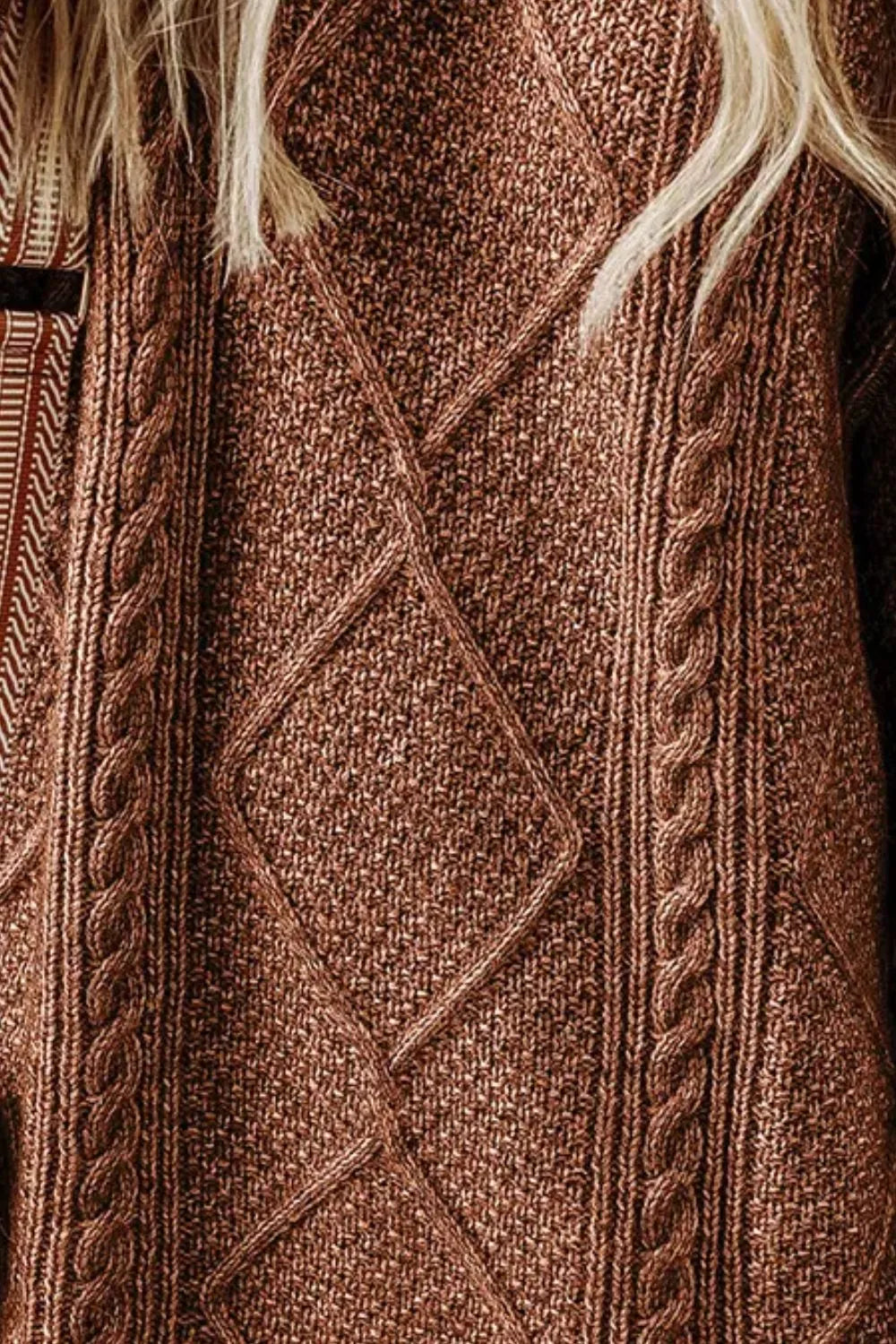 Brown cable-knit sweater dress with diamond pattern and round neckline close-up.