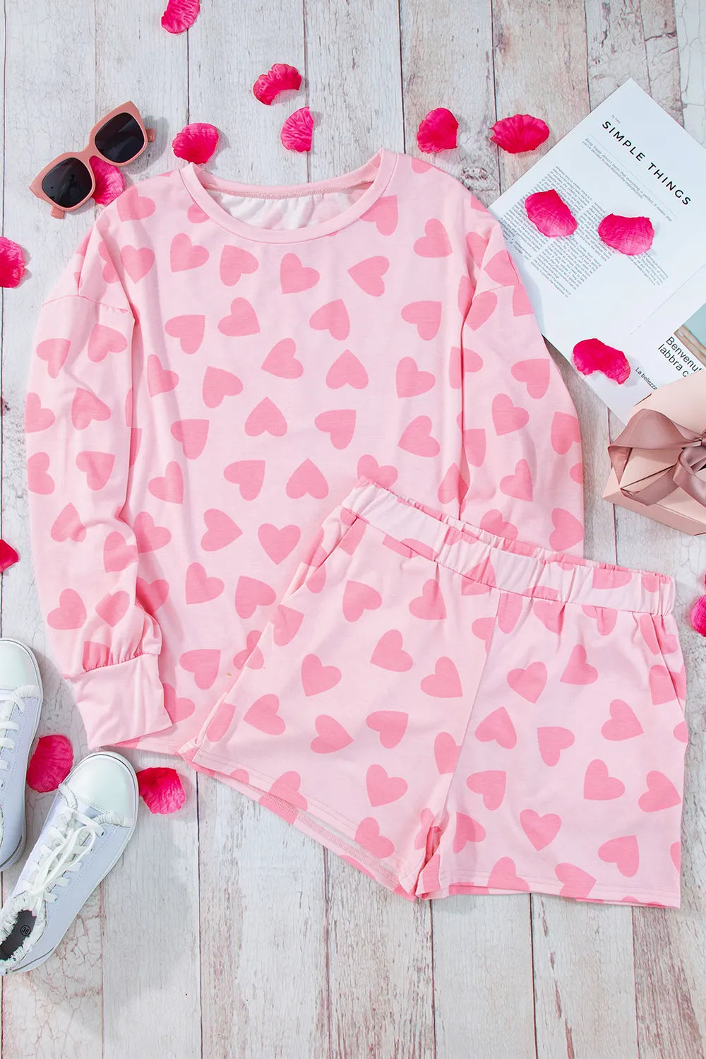 Blush pink long sleeve top and shorts set with all-over darker pink heart print and elastic waistband shorts.