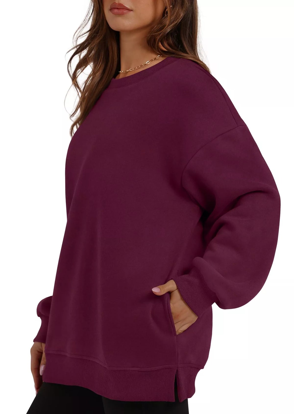 Burgundy casual long sleeve sweatshirt with relaxed fit and side slits, worn with hands in pockets.