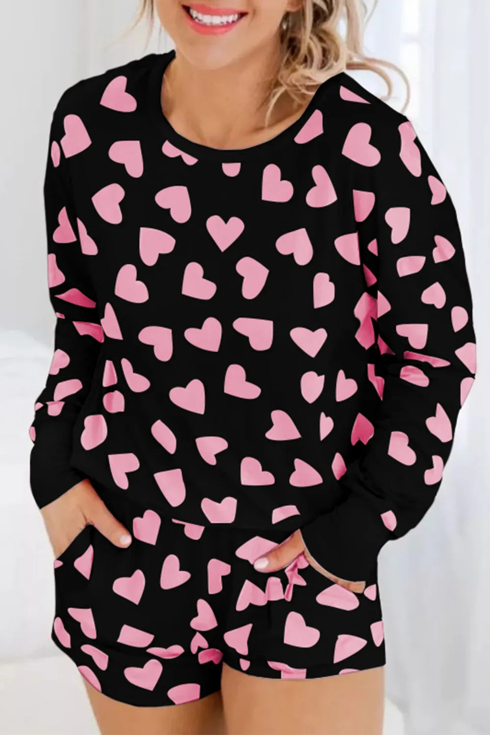 Black long sleeve top and shorts lounge set with large blush pink heart prints.
