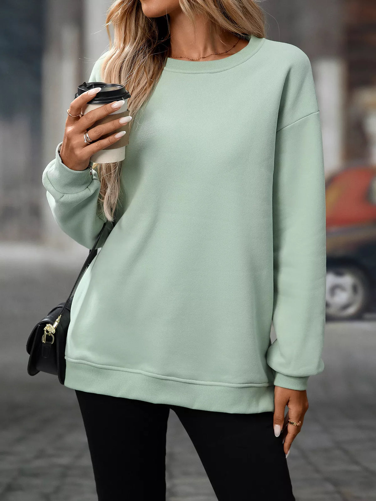 Light green long sleeve crewneck sweatshirt with relaxed fit and ribbed cuffs and hem.