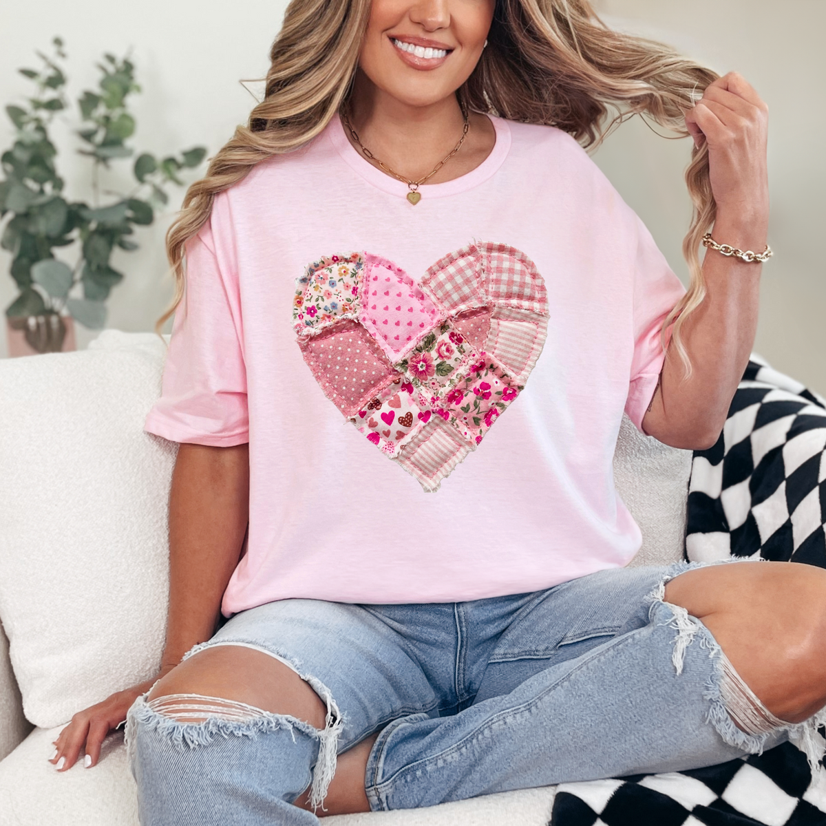 Light pink oversized tee with large patchwork heart in floral and plaid patterns on front.