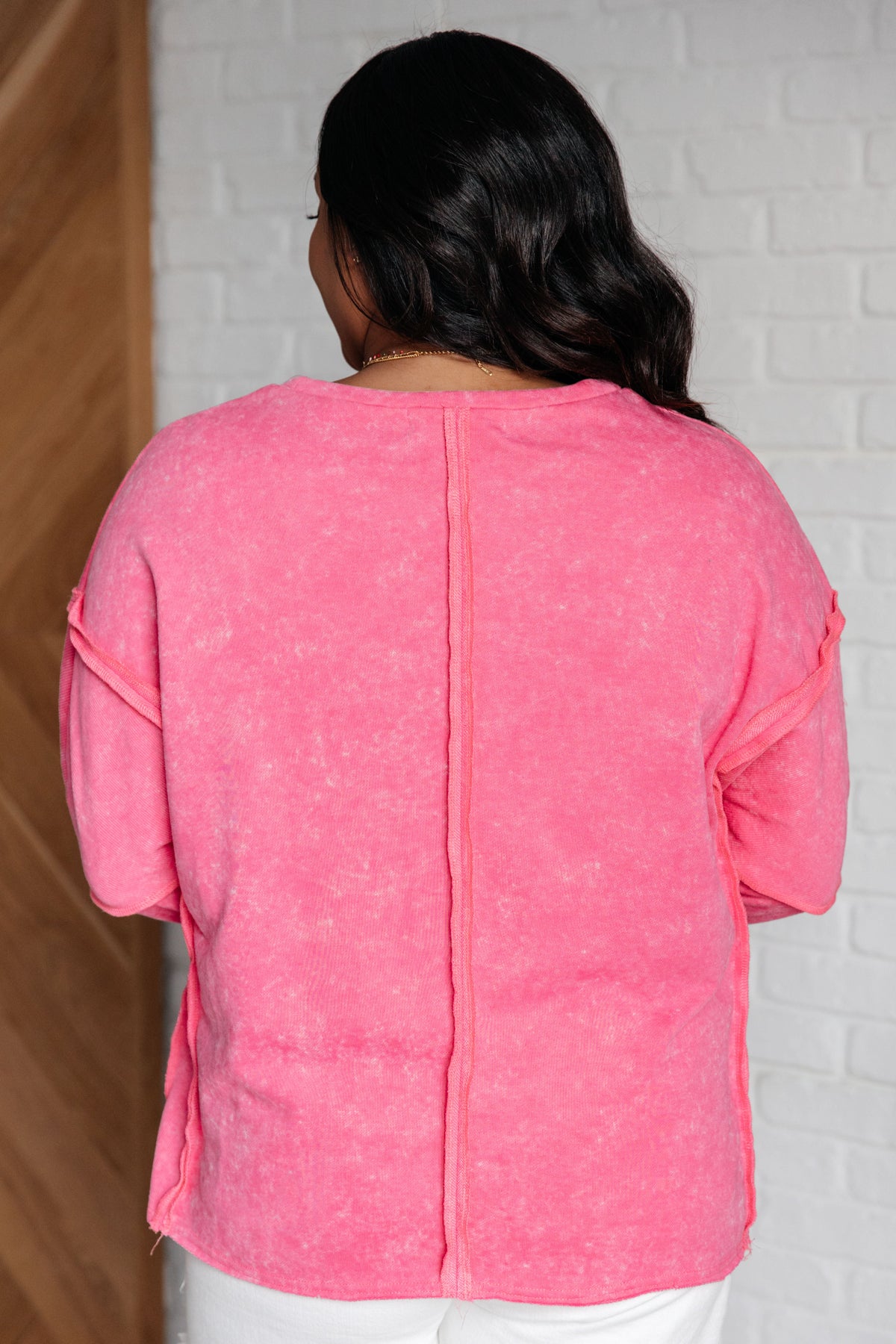 Hot pink patchwork long sleeve sweatshirt with visible seam down back, relaxed fit.