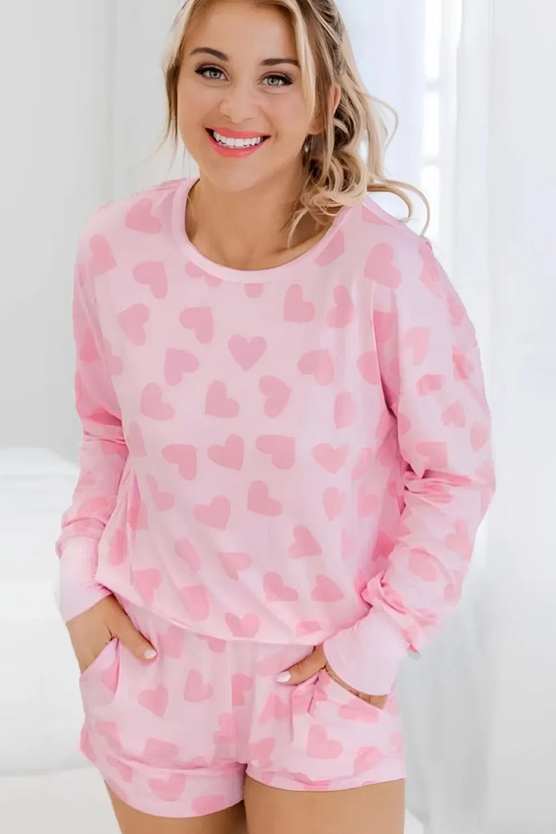 Blush pink long sleeve top and shorts lounge set with all-over heart print and casual fit.