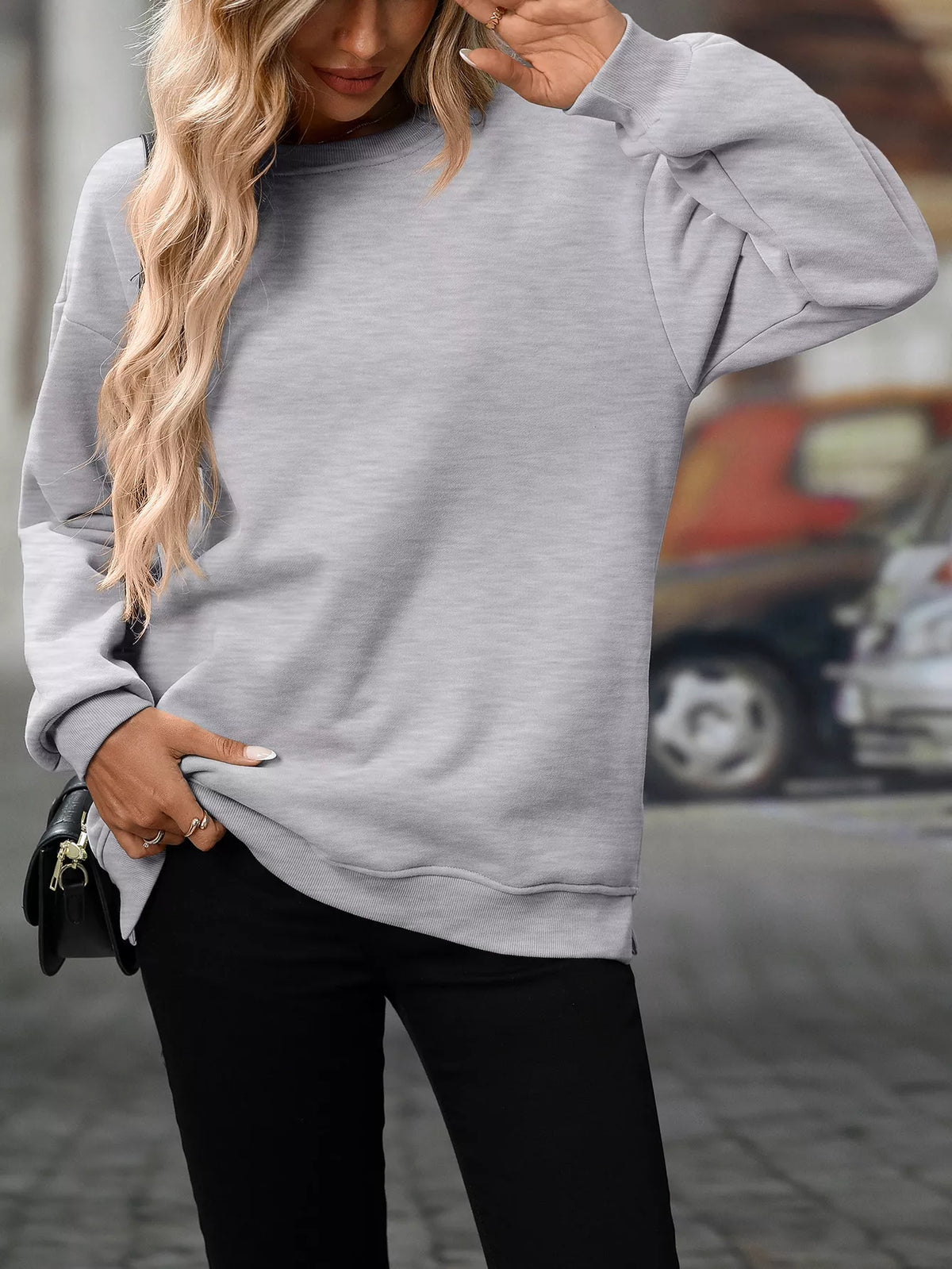 Light gray casual long sleeve sweatshirt with relaxed fit and ribbed cuffs.