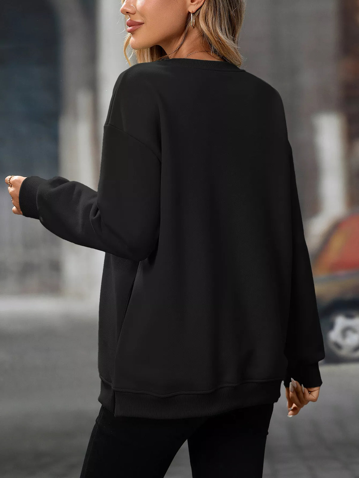 Black long sleeve casual sweatshirt with a relaxed fit and crew neckline.